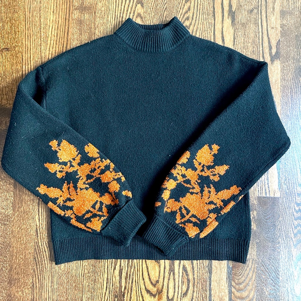 Black turtleneck sweater with copper floral sleeve detail